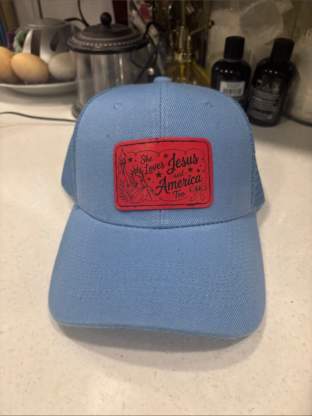 Light Blue Trucker Hat with Red Patch - She Loves Jesus and America